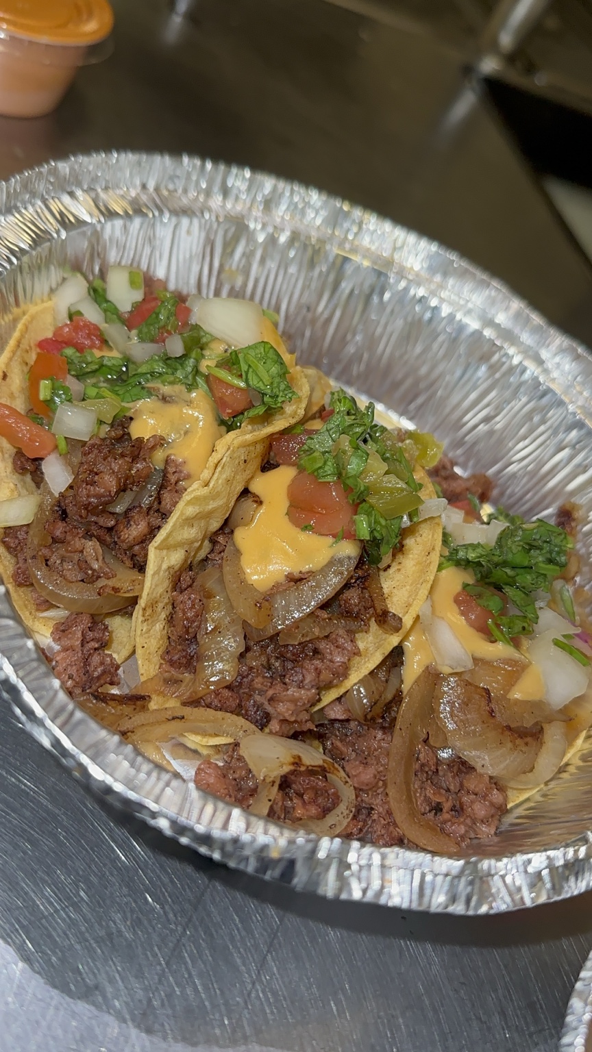 Sunshine's vegan tacos with plant-based meat, onions, greens and sauce